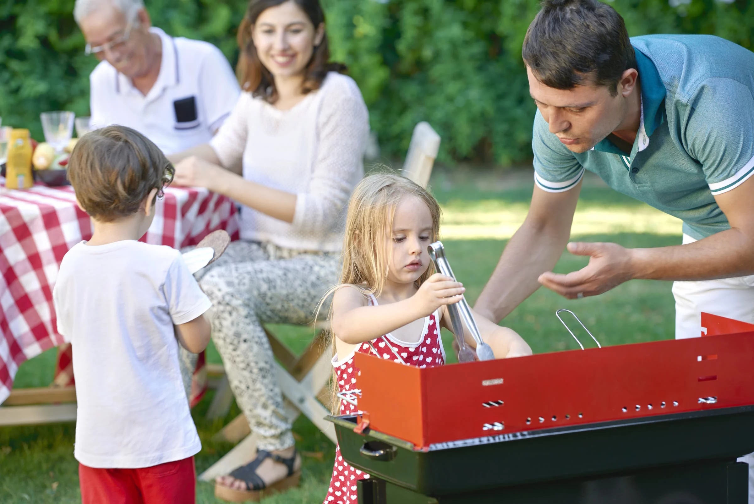 Family enjoying backyard barbecue