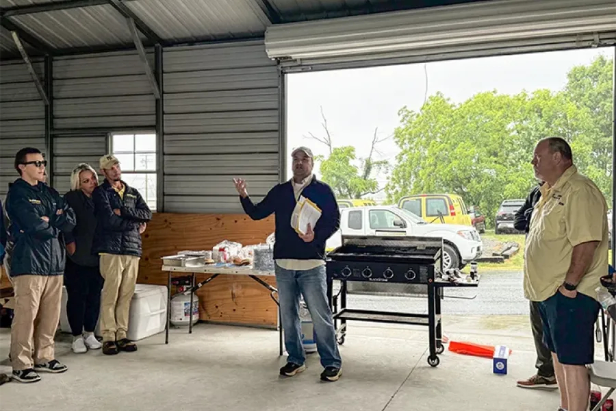 Tailor Made Lawns owner spending time with the team at a BBQ