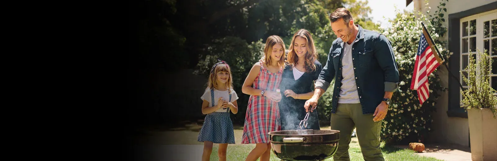 Family grilling outside in mosquito free yard