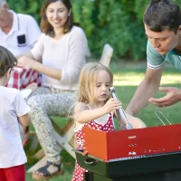 Family enjoying backyard barbecue